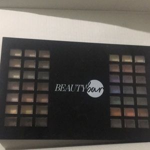 Makeup pallet with bronzer, blush, and lipstick